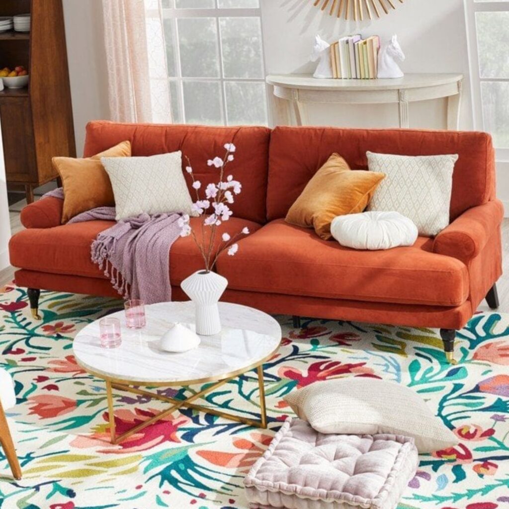 round coffee table with an orange sofa