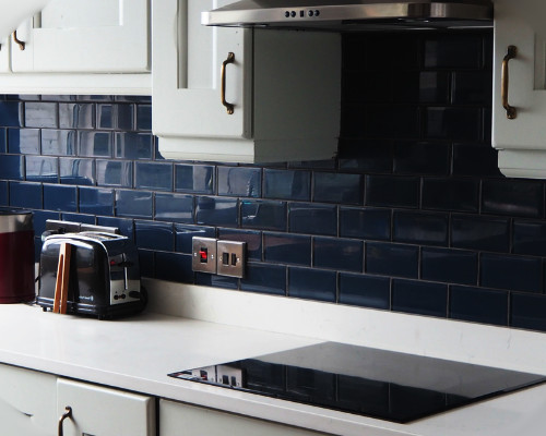 white cabinets and blue or navy tiles
